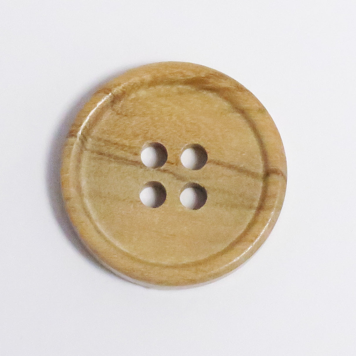 Button with four holes in olive wood